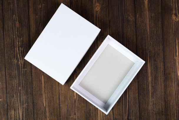 Empty white gift box or tray for mock up on dark wooden table wi - Photo, image
