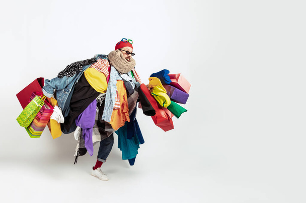Man addicted of sales and clothes, overproduction and crazy demand - 写真・画像