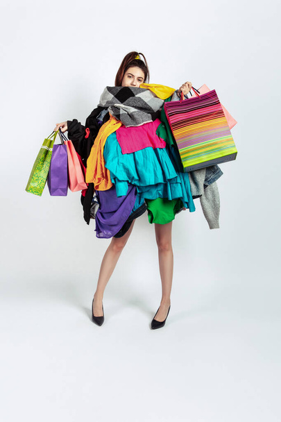 Woman addicted of sales and clothes, overproduction and crazy demand - Fotografie, Obrázek