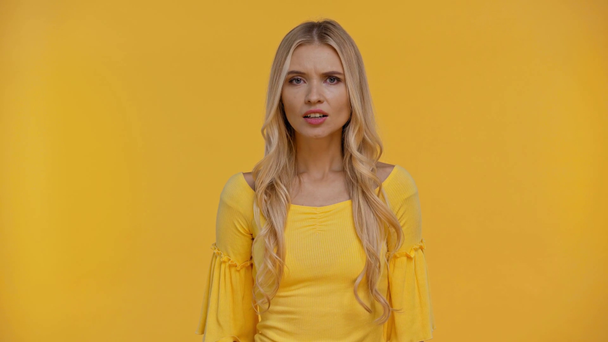 smiling, shocked, imitated woman isolated in yellow - Záběry, video