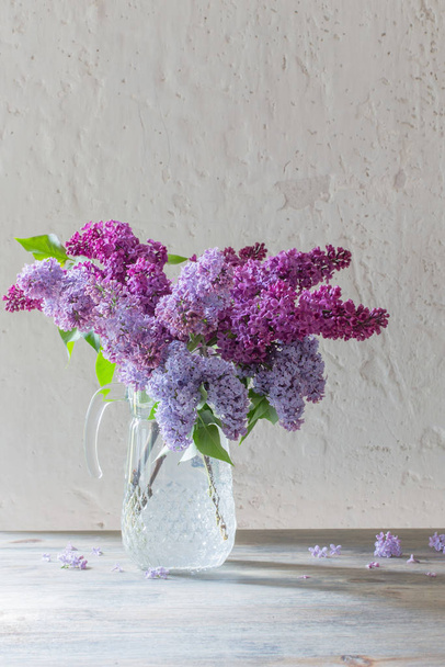 bouquet of lilacs in a glass jug - 写真・画像