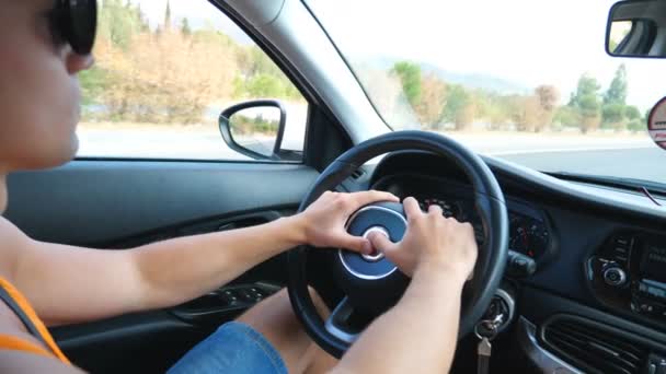 晴れた夏の日に国の道路を介してハンドルや運転車に手を握って認識できない男。高速で高速道路で自動車に乗る男を制御する。道路の旅の概念。スローモーション - 映像、動画