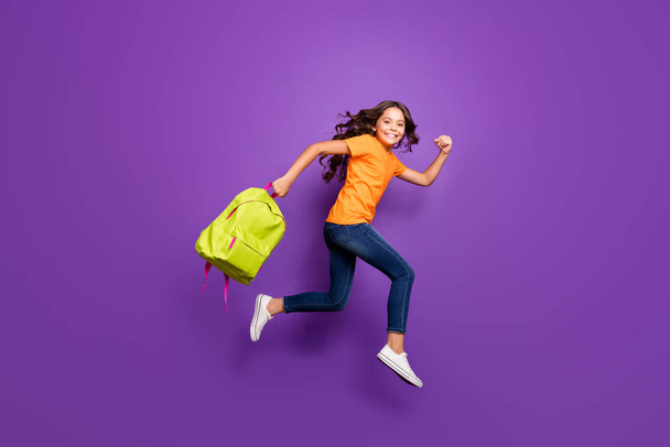 Full length body size view of nice attractive lovely cheerful cheery wavy-haired girl jumping carrying bag running autumn fall 1 first September isolated on lilac purple violet pastel color background - Foto, Imagem