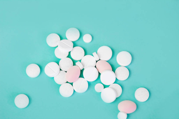 pills on a turquoise background. Health and Vitamins - Фото, зображення
