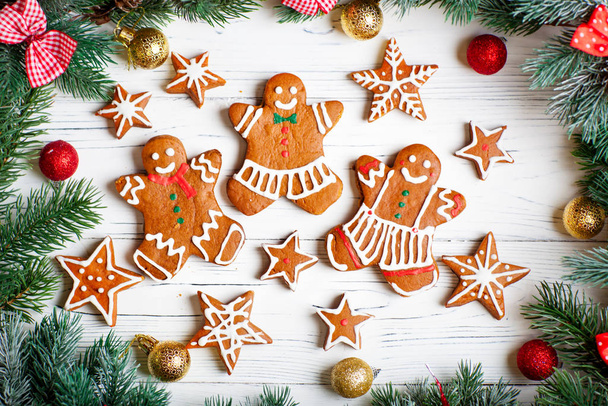 Handmade festive gingerbread cookies in the form of stars, snowflakes, people for Christmas and new year holiday on a white wooden table. - Valokuva, kuva