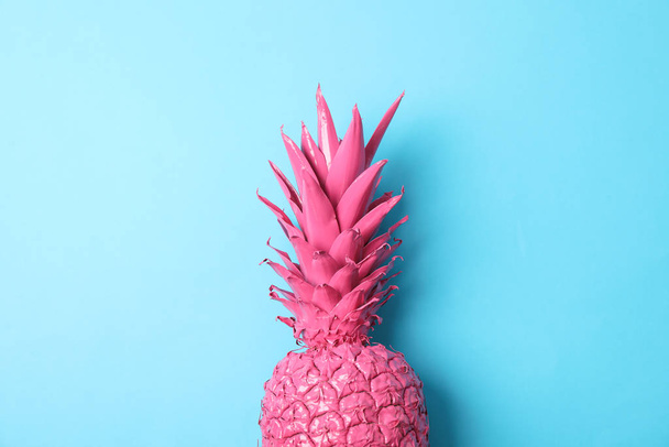 Painted pink pineapple on blue background, space for text - Valokuva, kuva