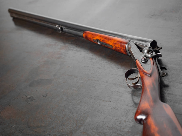 Shotgun. The old gun. Double-barreled gun. Retro weapon. Rifle. Iron background - Photo, Image