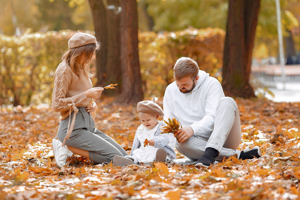 Family with little daughter in a autumn park - Φωτογραφία, εικόνα
