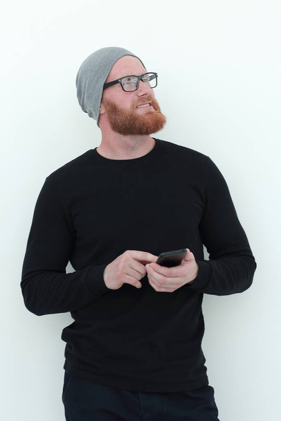 beautiful bearded man with smartphone looking at blank space - Photo, image