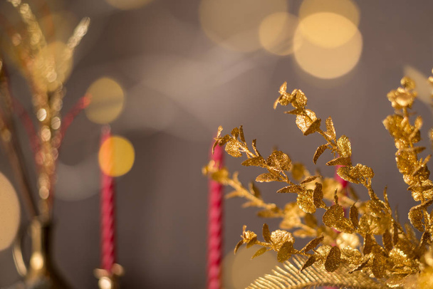 Christmas background gold branches decorations on the background of Christmas lights and candles - Foto, Imagem