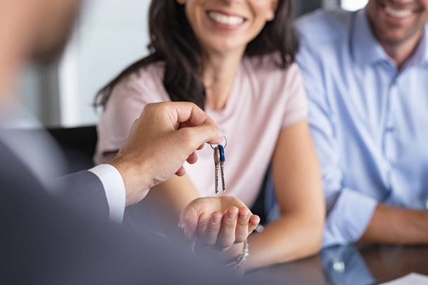 Real estate agent giving house keys to woman - Fotó, kép