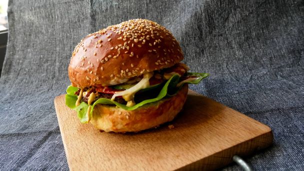 Meaty hamburger in a restaurant - Fotoğraf, Görsel