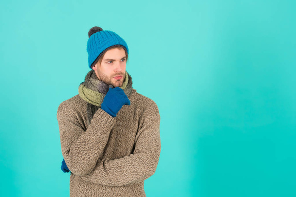 Cozy winter vibes. Thoughtful man blue background. Handsome man in winter style design. Casual outfit designed for winter wardrobe. Style and fashion. Warm wear for cold winter weather, copy space - Photo, Image
