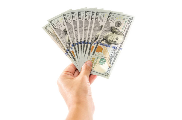 Dólares en mano sobre fondo blanco
 - Foto, imagen