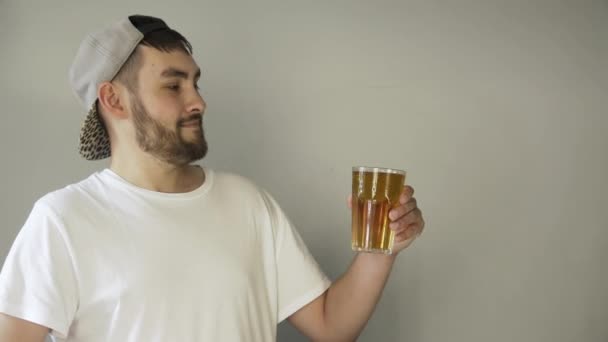 Person lifts yellow beer closeup and looks at the camera, showing thumb up 4K - Video
