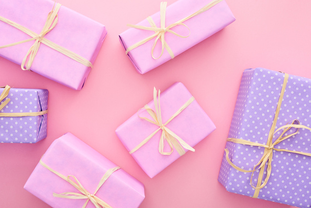 top view of colorful gift boxes with bows isolated on pink  - Fotó, kép