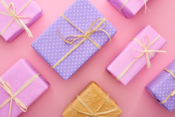 κορυφή άποψη των πολύχρωμο και τυλιγμένο κουτιά δώρο σε ροζ  - Φωτογραφία, εικόνα