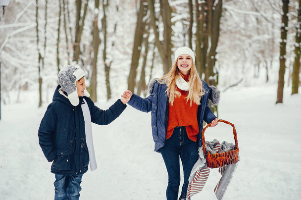 Mother with cute son in a winter oark - Photo, Image