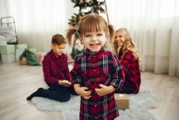Family sitting near Christmas gifts - Valokuva, kuva
