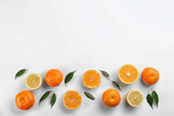 Flat lay composition with tangerines and lemons on white background. Space for text - Zdjęcie, obraz