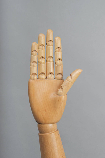 wooden hand of dummy in grey background - Foto, Imagen