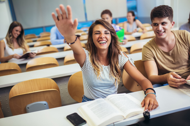Group of students raising hands in class on lecture - Photo, Image