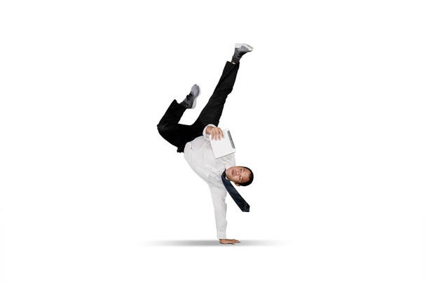 Businessman doing handstand over white background - Photo, Image