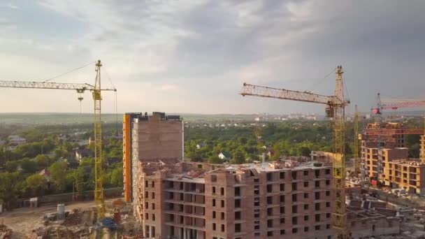 Luchtfoto van bouwplaats met bouwkranen en flatgebouwen in een stad. - Video