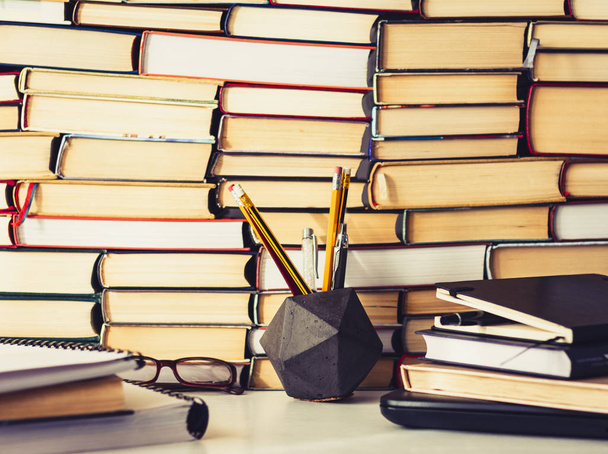 Stack of books, notebook, laptop, glasses in office background f - Photo, image