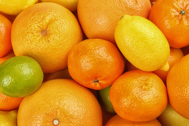 Tangerines, oranges, lime and lemon as background, top view - Фото, изображение