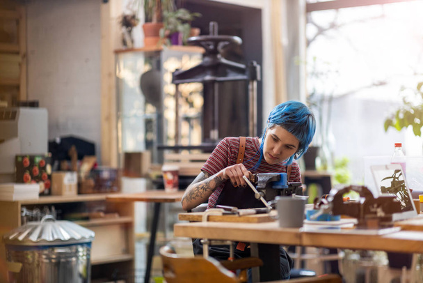 Confident young craftswoman in her workshop - Φωτογραφία, εικόνα