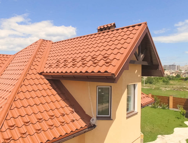House with a new roof made of orange metal. View from above. Cor - Photo, Image