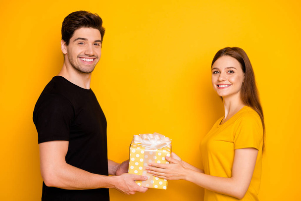 Photo of cheerful positive nice charming pretty couple of spouses celebrating brithday of girlfriend wearing black t-shirt smiling toothily isolated over vivid color background - Fotografie, Obrázek
