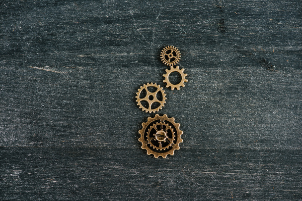 top view of vintage metal gears on dark wooden background with copy space - Photo, Image