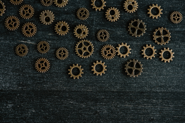 top view of vintage metal gears on dark wooden background - Fotografie, Obrázek