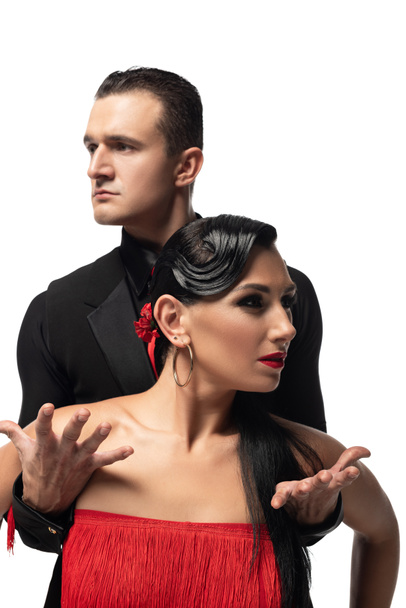 stylish, sensual dancers looking in opposite sides while performing tango isolated on white - Valokuva, kuva