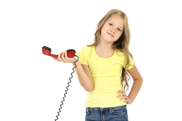 Beautiful little girl with handset on white background - Foto, imagen