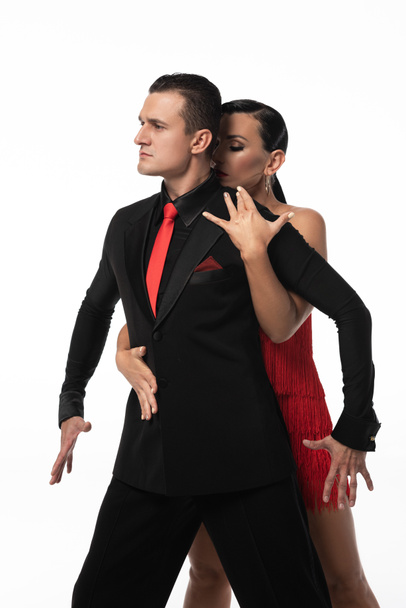attractive dancer hugging partner from back while performing tango isolated on white - Φωτογραφία, εικόνα
