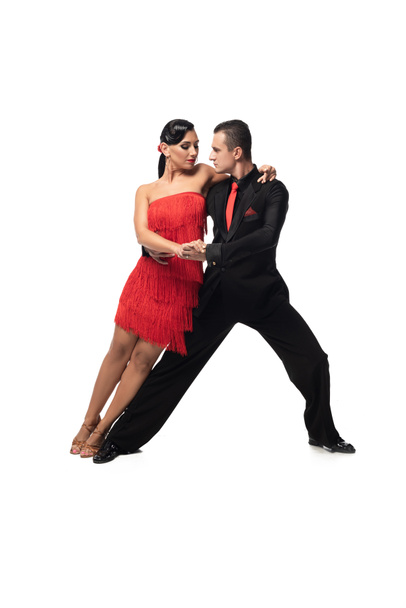 elegant couple of dancers performing tango on white background - Photo, Image