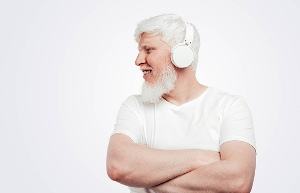 Albino male with headphones on white background - Foto, imagen