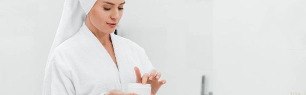 panoramic shot of woman holding container with face cream - Foto, immagini