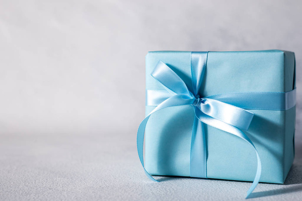 present box with blue bow isolated on gray background - Fotoğraf, Görsel
