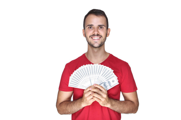 Young happy man holding dollar banknotes on white background - Zdjęcie, obraz