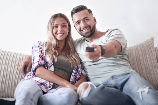 Young couple enjoying themselves on the sofa in the living room - Foto, Bild