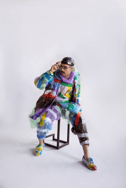 Man addicted of sales and clothes, wearing plastic, recycling concept - Photo, Image