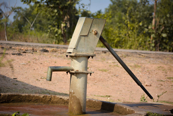 Oude met de hand bediende waterpomp in landelijk India - Foto, afbeelding