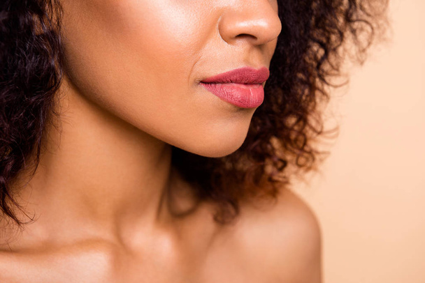 Cropped close up side profile photo beautiful she her dark skin model lady enjoy new made perfect big lips size correction pink tender tempting color wear nothing isolated pastel beige background - Fotografie, Obrázek