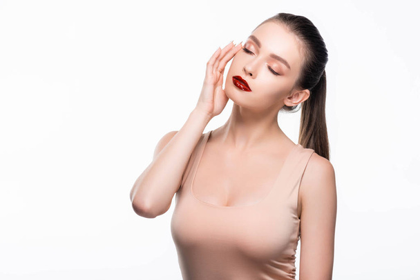 attractive young woman touching face with closed eyes isolated on white - Valokuva, kuva