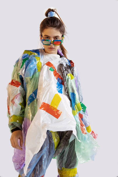 Woman addicted of sales and clothes, wearing plastic, recycling concept - Fotoğraf, Görsel