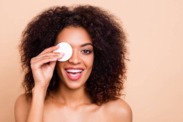 Close-up portrait of her she nice-looking attractive fascinating shine cheerful positive wavy-haired girl closing covering eye facial soft gel lotion water isolated over beige pastel background - Zdjęcie, obraz